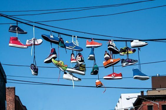 Sneakers hanging above the street